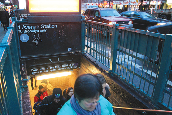 Straphangers exiting the cramped L train station at 14th St. and First Ave.  Photo by Zach Williams
