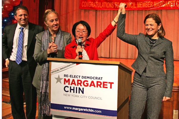 Councilmember Chin, raised her hand with Councilmember Melissa Mark-Viverito, at Chin's swearing in ceremony Jan. 5. At left is Councilmember Brad Lander and Borough President Gale Brewer. Downtown Express photo by Sam Spokony.
