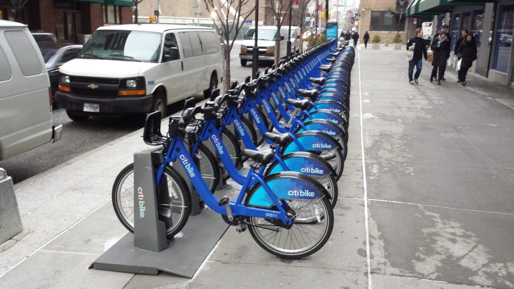 At this bike-share docking station, at Hudson and W. Houston Sts., on Thursday around 12:30 p.m., there were only two slots open. D.O.T. and NYC Bike Share say bikes from on-street bike stations on major streets will be removed for the blizzard -- but will there be anyplace to put them?  Photo by Lincoln Anderson