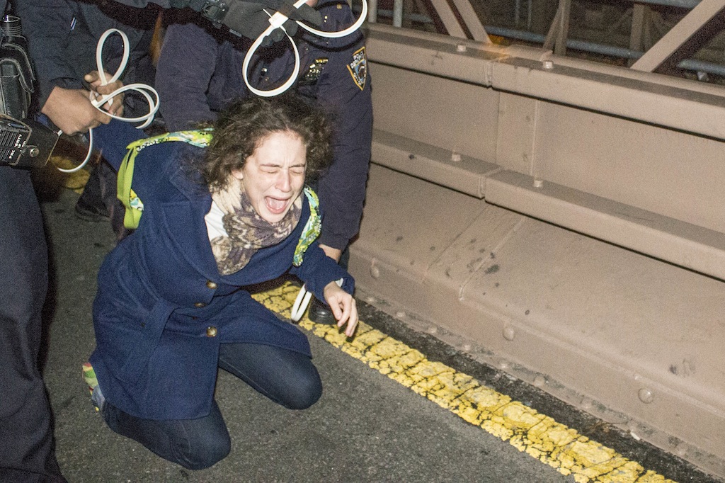 A female protester screamed as police handcuffed her on the Brooklyn Bridge.