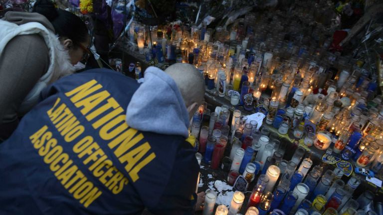 The makeshift memorial for slain NYPD detectives Wenjian Liu and Rafael Ramos at the intersection of Tompkins Avenue and Myrtle Avenue in Brooklyn. 