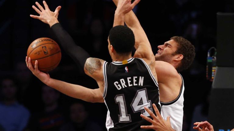 Danny Green of the San Antonio Spurs defends a scoring chance against Brook Lopez of the Brooklyn Nets during an NBA game at Barclays Center on Wednesday, Dec. 3, 2014.