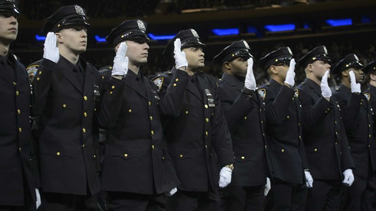 The New York City Police Department's graduating class of December 2014 takes the oath of office during a ceremony at Madison Square Garden on Monday, Dec. 29, 2014.
