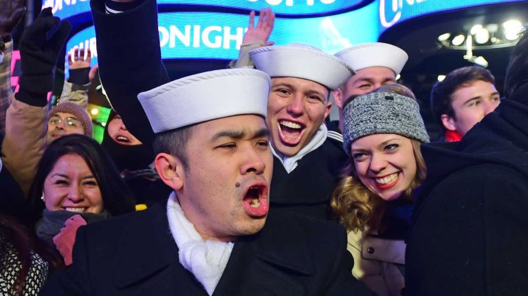 Navy Seamen Tom Tonthat and Zackary Landers, both from Fort Meade, celebrate New Year's Eve along with Nadine Thomas of Nova Scotia, far right, in Times Square on Dec. 31, 2014.