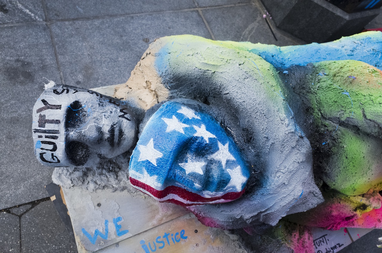 The "Guilty System" is unmasked in Washington Square Park at the start of the Dec. 13 Millions March NYC     Photo by Milo Hess