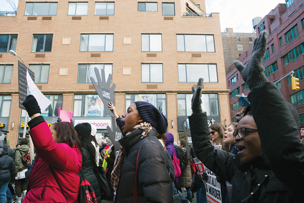 “I Can’t Breathe” and “Hands up! Don’t shoot!” the protesters cried out as they wended their way up to E. 32nd St. before heading back Downtown.  Photo by Q. Sakamaki