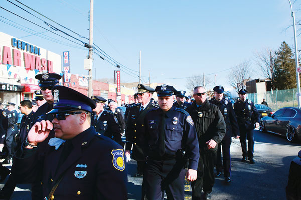In a show of solidarity, police came to the funeral from near and far, including these officers from White Plains and Cranston, Rhode Island.