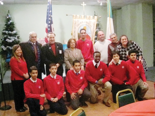 Figli di San Gennaro board members with students from the East Village’s La Salle Academy at the Jan. 6 presentation of charitable checks from proceeds from the Feast of Gennaro.
