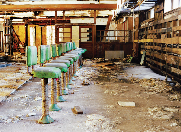 At the coffee shop of Grossinger’s Catskill Resort and Hotel, in Liberty, NY, all that’s recognizable are 10 dust-covered green stools.    © Marisa Scheinfeld, 2011 