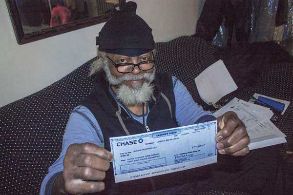 Jimmy McMillan displayed a check that would pay about two-thirds of his back rent, but he said his landlord won’t accept it.  Photos by Zach Williams