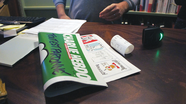 A new issue of Charlie Hebdo, purchased in New York City, with the receipt to prove it.   Photo by Liza Bear