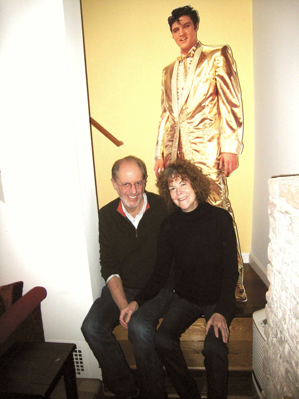 Alan Grossman, left, and Andrea Shaw in their apartment, which features a cutout of the King.   Photo by Lesley Sussman