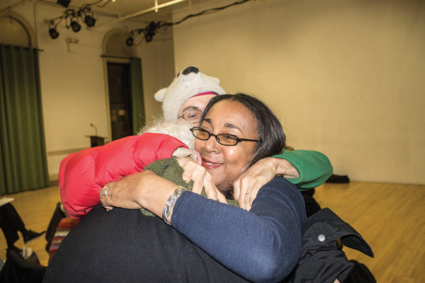 Ayo Harrington, a garden activist and C.B. 3 member, hugged fellow gardeners after the full community board voted to recommend approval of the community gardens district plan.   Photos by Zach Williams