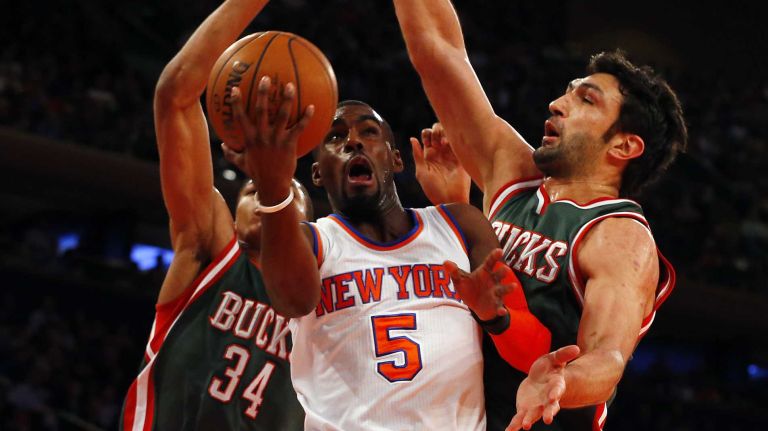 Tim Hardaway Jr. #5 of the New York Knicks goes to the hoop against Giannis Antetokounmpo #34 and Zaza Pachulia #27 of the Milwaukee Bucks at Madison Square Garden on Sunday, Jan. 4, 2015.