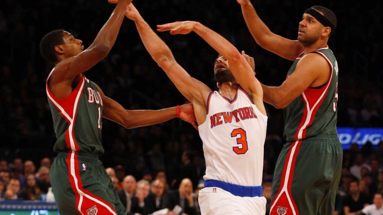 Jose Calderon #3 of the New York Knicks loses the ball between against Brandon Knight #11 and Jared Dudley #9 of the Milwaukee Bucks at Madison Square Garden on Sunday, Jan. 4, 2015.