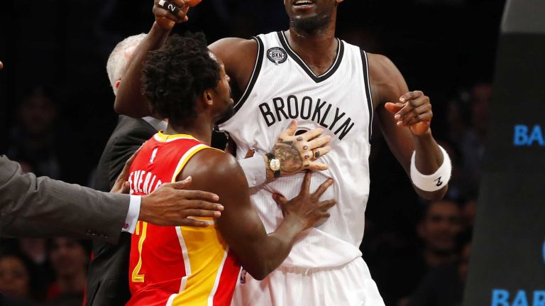 Kevin Garnett #2 of the Brooklyn Nets is held back by Patrick Beverley #2 of the Houston Rockets as he reacts after a first-quarter confrontation against Dwight Howard #12 (not pictured) at Barclays Center on Monday, Jan. 12, 2015.