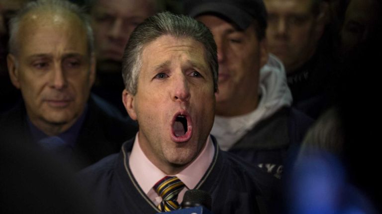 Patrick Lynch, head of the Patrolmen's Benevolent Association, speaks during a news conference after the bodies of two fallen NYPD police officers were transported from Woodhull Medical Center on Saturday, Dec. 20, 2014. 