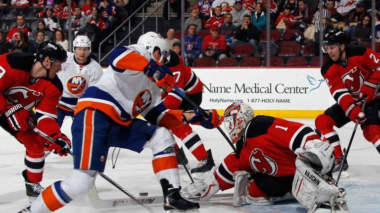Keith Kinkaid of the New Jersey Devils pushes out a first period shot during the game against the New York Islanders at the Prudential Center on Jan. 9, 2015 in Newark, N.J.