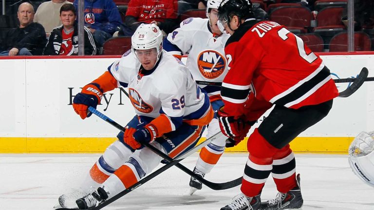 Brock Nelson of the New York Islanders carries the puck against Marek Zidlicky of the New Jersey Devils during the first period at the Prudential Center on Jan. 9, 2015 in Newark, N.J.
