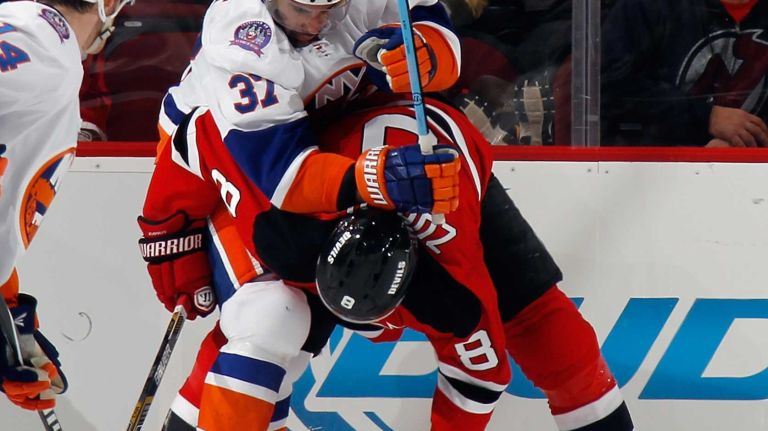 Brian Strait of the New York Islanders and Dainius Zubrus of the New Jersey Devils battle during the first period at the Prudential Center on Jan. 9, 2015 in Newark, N.J.