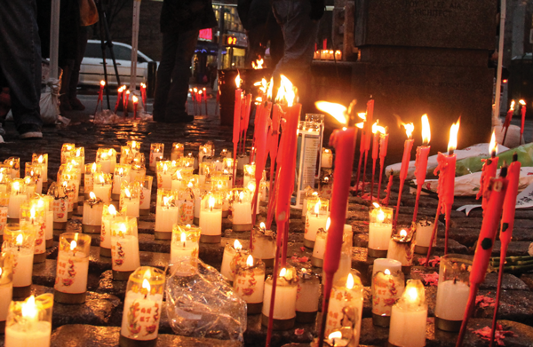 Councilmember Margaret Chin, below, held a votive candle at the memorial. 