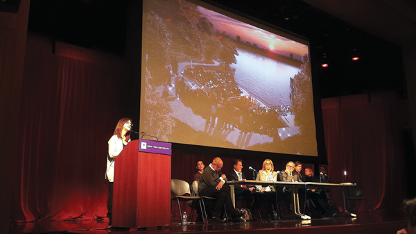 Kate Horton described Pier55’s planned programming at the public hearing on the proposed Hudson River Park project. On the screen behind her is a design image of the the pier's planned 700-seat amphitheater. Photo by The Villager