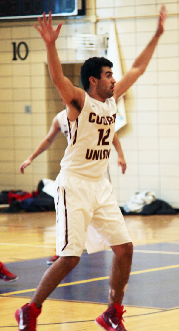 Adam Jamia-O-Connor, shown with his hands up on defense, scored 18 points and hauled in 16 rebounds.