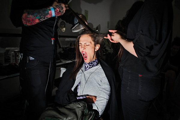 A model yawns while getting ready backstage at the Rodarte fashion show. New York Fashion Week, Spring 2013.  Courtesy of Anastasia Photo ©Dina Litovsky