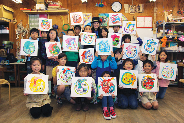 Participants from Japan, above, and Haiti, below, in the Hearts of the World project show their artwork.