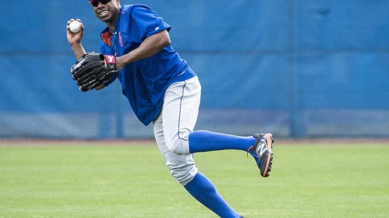 NY Mets outfielder Curtis Granderson catching fly balls during a spring training workout Tuesday Feb 24, 2015.