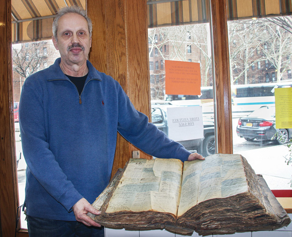 Abe Lerner with a historic prescription book at Avignone, which had a pharmacy for all but the last year of its more than 100 years.  Photos by Tequila Minsky