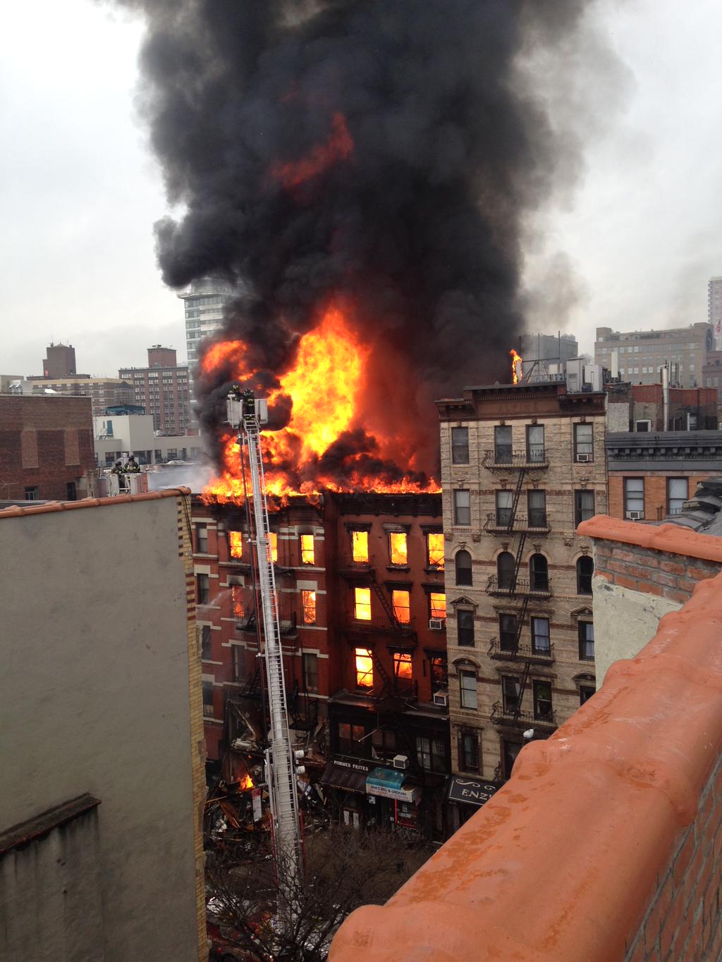 After the explosion rocked 125 Second Ave., a fire broke out in the building, and then spread to the adjoining building to the north.  Photo via Twitter / @liberation nyc