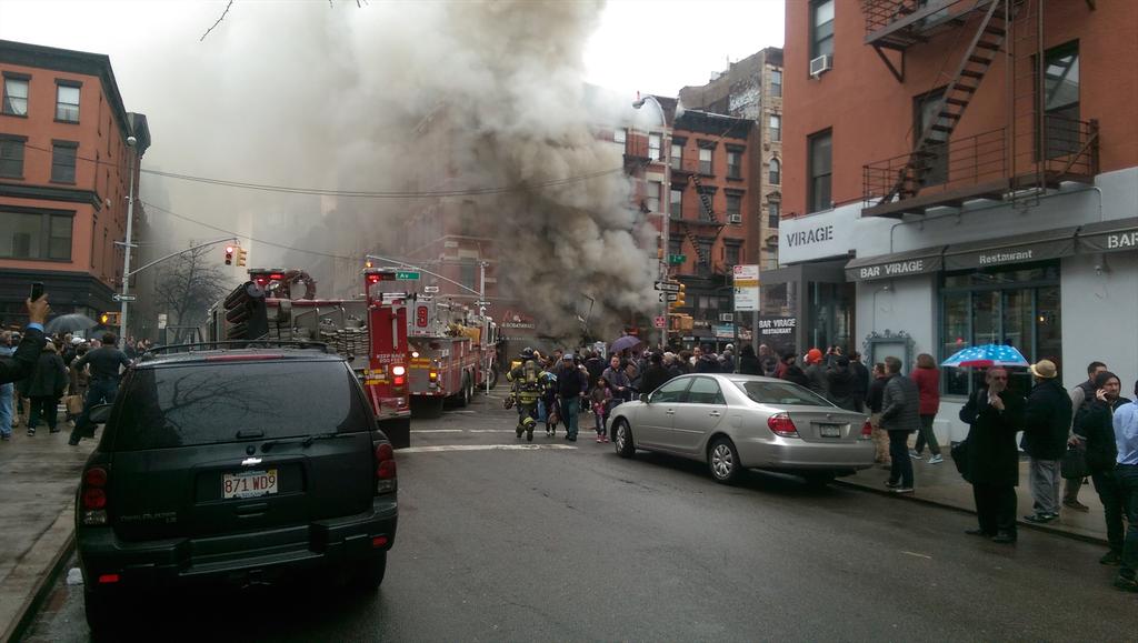 Smoked spewed out of the second building from the intersection's northwest corner after it suffered a partial collapse on Thursday afternoon.  Photo by JK @Jamie_S_Kennedy