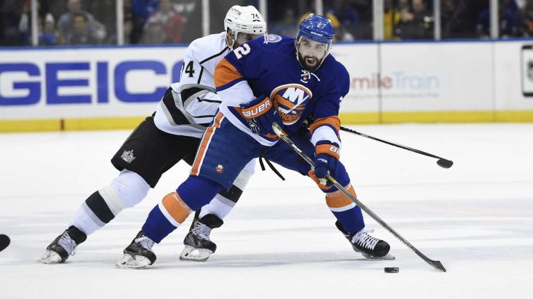 New York Islanders defenseman Nick Leddy skates against Los Angeles Kings left wing Dwight King in the first period of an NHL hockey game at Nassau Coliseum on Thursday, March 26, 2015.