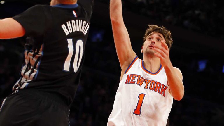 Alexey Shved #1 of the New York Knicks attempts a shot against Chase Budinger #10 of the Minnesota Timberwolves during the first half at Madison Square Garden on Thursday, March 19, 2015.