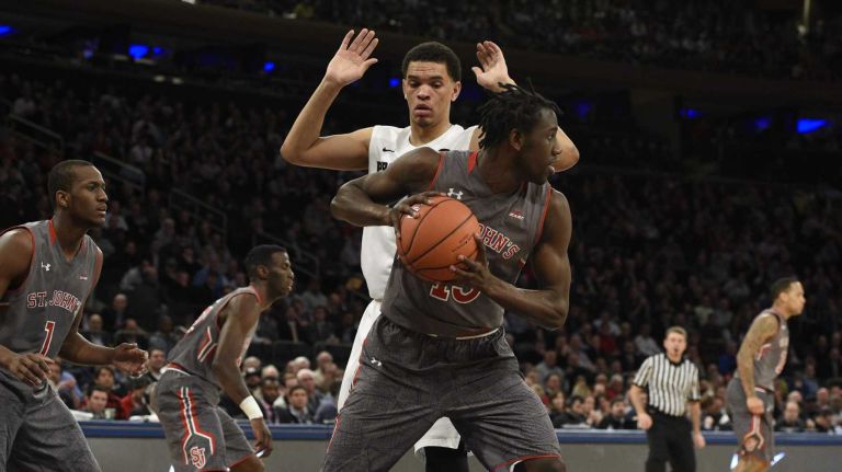St. John's Red Storm guard Sir'Dominic Pointer pulls in a rebound against Providence Friars forward Tyler Harris in a Big East quarterfinal men's basketball game at Madison Square Garden on Thursday, March 12, 2015.