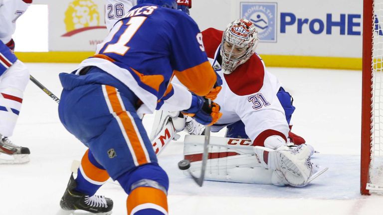 Carey Price of the Montreal Canadiens makes a save in the first period against John Tavares of the New York Islanders at Nassau Coliseum on Saturday, March 14, 2015.