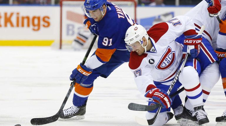 John Tavares of the New York Islanders battles for the puck after a face off in the first period against Torrey Mitchell of the Montreal Canadiens at Nassau Coliseum on Saturday, March 14, 2015.