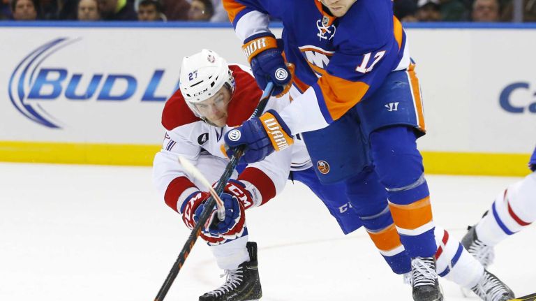 Matt Martin of the New York Islanders battles for the puck in the first period against Alex Galchenyuk of the Montreal Canadiens at Nassau Coliseum on Saturday, March 14, 2015.