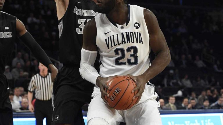 Villanova Wildcats forward Daniel Ochefu is defended under the basket by Providence Friars forward Carson Desrosiers in a Big East semifinal men's basketball game at Madison Square Garden on Friday, March 13, 2015.