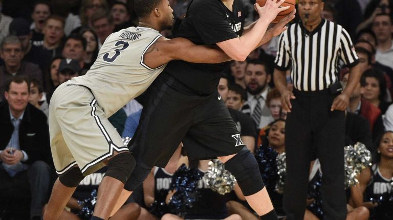 Big East Tournament semifinal: Georgetown vs. Xavier 28 Xavier Musketeers center Matt Stainbrook is defended by Georgetown Hoyas forward Mikael Hopkins in a Big East semifinal men's basketball game at Madison Square Garden on Friday, March 13, 2015.