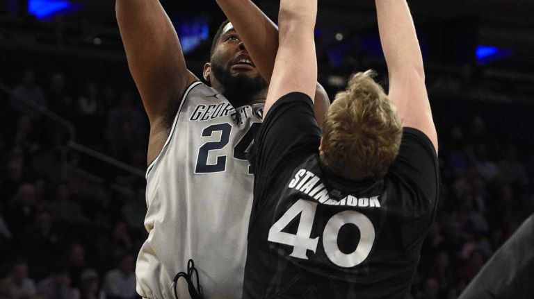 Big East Tournament semifinal: Georgetown vs. Xavier 43 Georgetown Hoyas center Joshua Smith shoots past Xavier Musketeers center Matt Stainbrook in a Big East semifinal men's basketball game at Madison Square Garden on Friday, March 13, 2015.