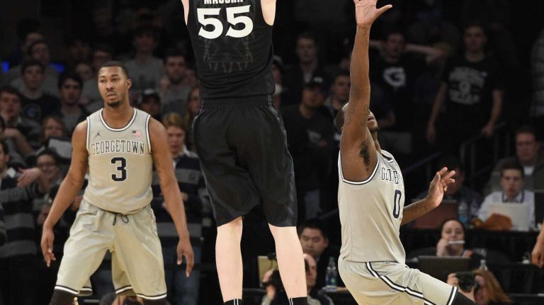 Big East Tournament semifinal: Georgetown vs. Xavier 45 Xavier Musketeers guard J.P. Macura sinks a three-point basket against the Georgetown Hoyas in a Big East semifinal men's basketball game at Madison Square Garden on Friday, March 13, 2015.