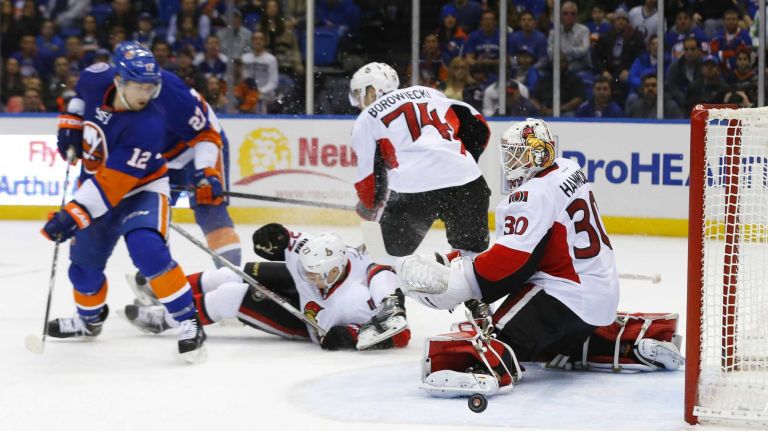 Andrew Hammond of the Ottawa Senators makes a third period save against Josh Bailey of the New York Islanders at Nassau Coliseum on Friday, March 13, 2015.