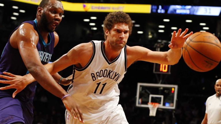 Brook Lopez of the Brooklyn Nets reaches for a loose ball in the first half against Al Jefferson of the Charlotte Hornets at Barclays Center on Wednesday, March 4, 2015.