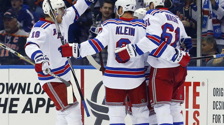 Rick Nash of the New York Rangers celebrates his third-period goal against the New York Islanders with teammates Kevin Klein and Marc Staal at Nassau Coliseum on Tuesday, March 10, 2015.