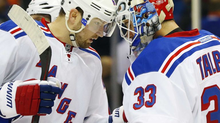 Rick Nash and Cam Talbot of the New York Rangers celebrate after defeating the New York Islanders at Nassau Coliseum on Tuesday, March 10, 2015.