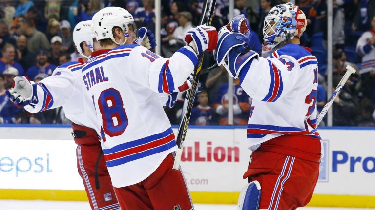 Cam Talbot and Marc Staal of the New York Rangers celebrate after defeating the New York Islanders at Nassau Coliseum on Tuesday, March 10, 2015.