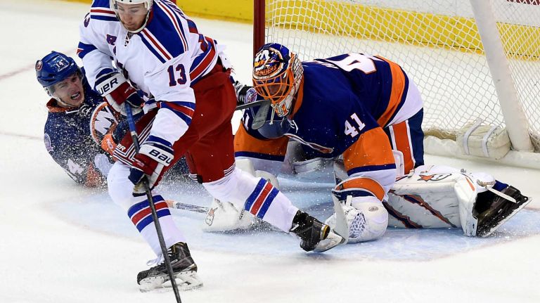 New York Rangers' Kevin Hayes score the tying goal against New York Islanders goalie Jaroslav Halak and defenseman Thomas Hickey in the second period at Nassau Coliseum on Tuesday, March 10, 2015.