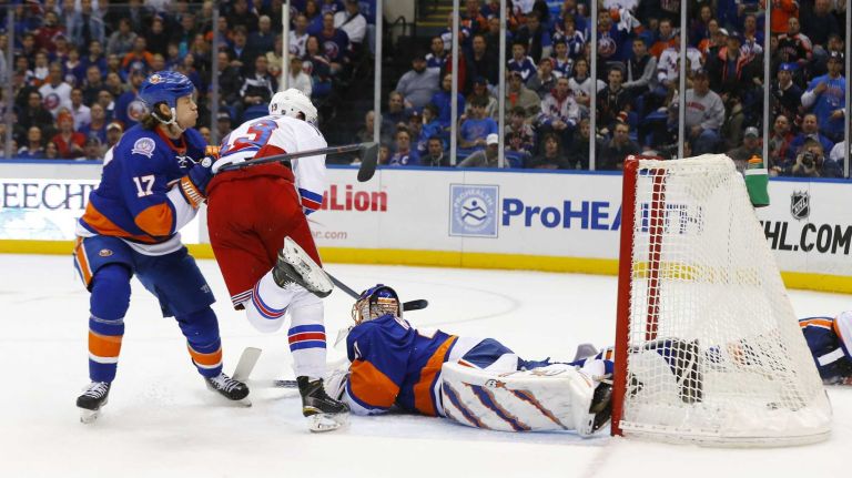 Kevin Hayes of the New York Rangers scores a second period goal past Jaroslav Halak of the New York Islanders at Nassau Coliseum on Tuesday, March 10, 2015.